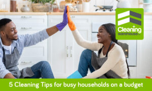 African man and woman giving high five on clean floor, cleaning tips for busy households.