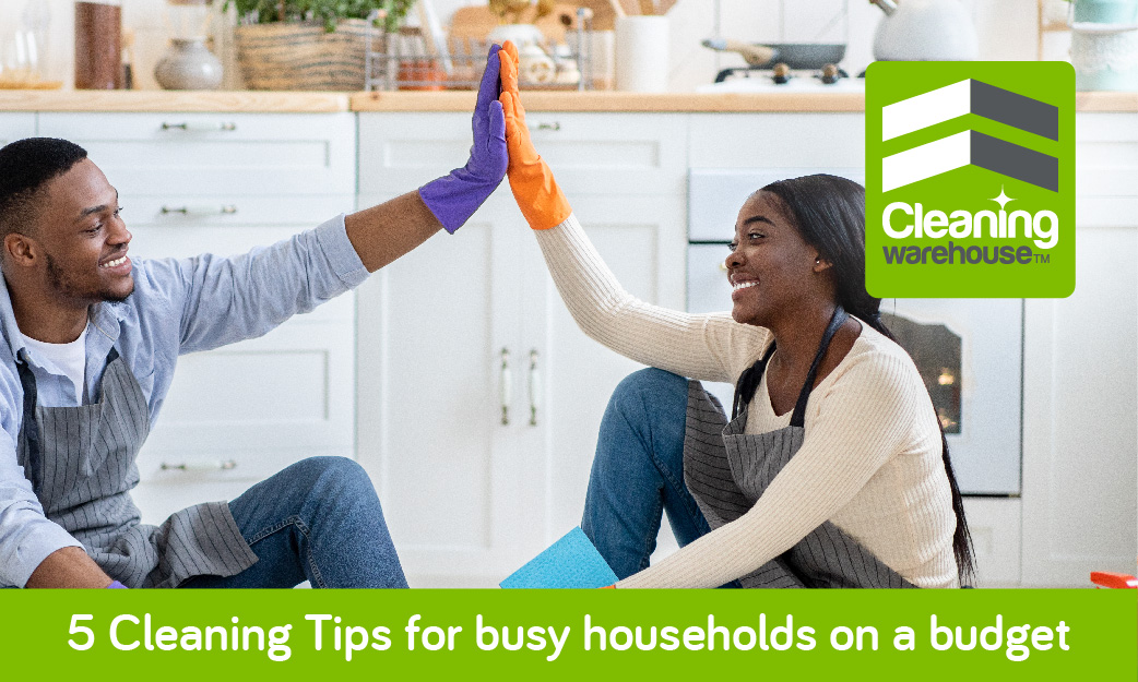 African man and woman giving high five on clean floor, cleaning tips for busy households.