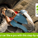 Clean your car like a pro with this step-by-step guide Man washing car tires with foam and water, promoting car care combo.